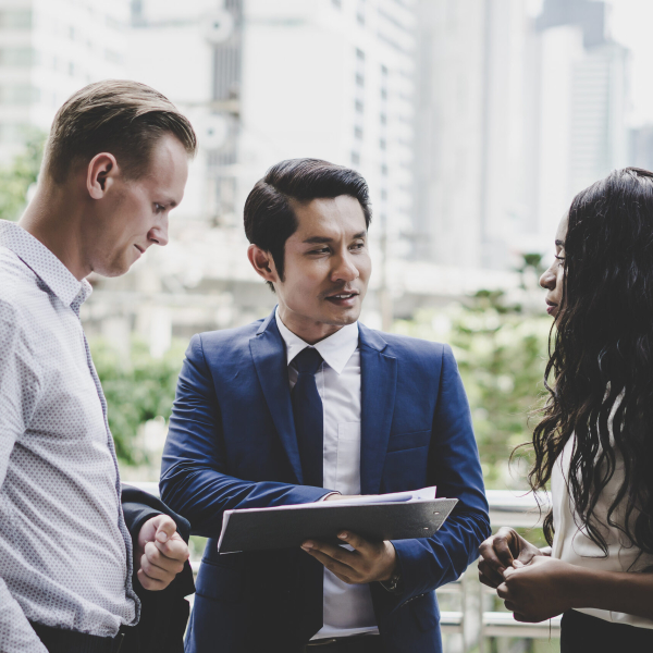 Business coworkers discussing new ideas and brainstorming together looking at new project document.